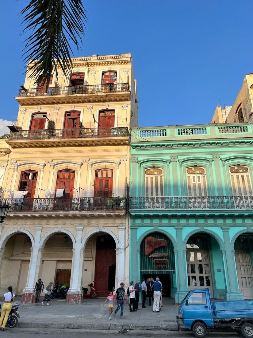 Pastel colonial buildings lining a street in Cuba