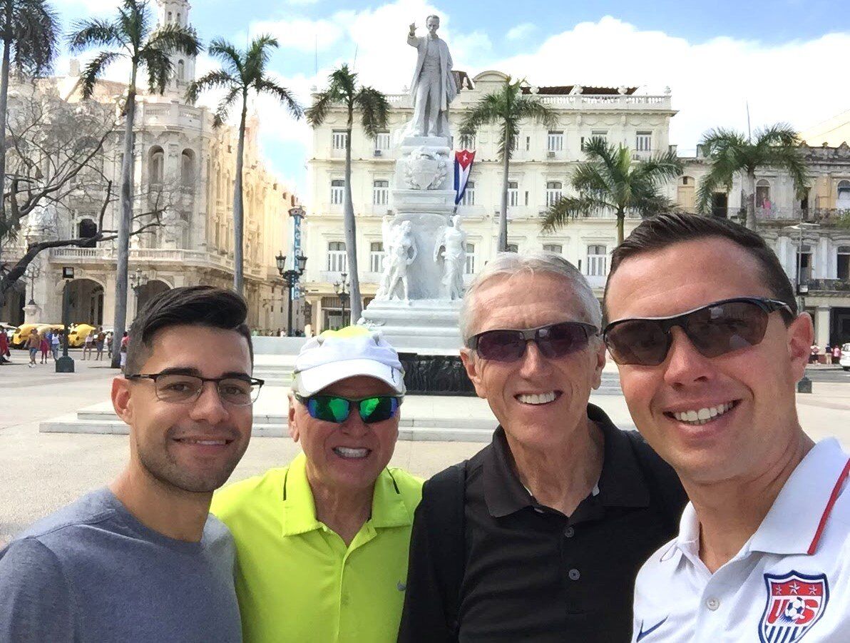 Four SAWB volunteers together in a city plaza during a service trip